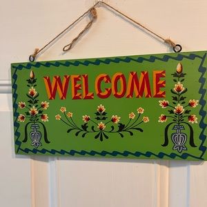 green welcome folk sign